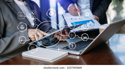 Business team working virtual tablet to emissions carbon CO2 climate change to limit global warming.Sustainable development and green business concept. at office - Shutterstock ID 2237395849