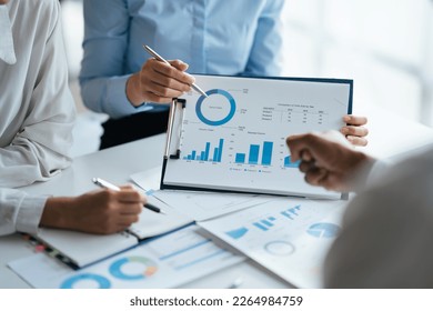 Business teamwork brainstorming meeting process. Business people discussing the charts and graphs showing the results of their successful teamwork.
