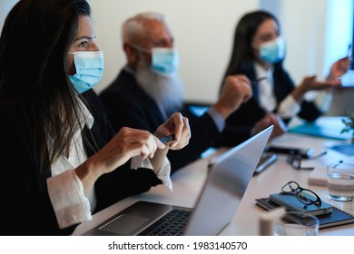 Business Teamwork Doing Meeting Inside Bank Office While Wearing Safety Mask During Coronavirus Outbreak - Finance And Healthcare Concept - Focus On Woman Left Hand