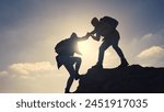 business. teamwork helps hand down business silhouette concept. a group of tourists lend a helping hand, climbing rocks, mountains, lend helping hand. teamwork people climbers climb to top travel