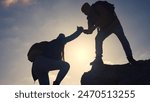 business. teamwork helps hand down business silhouette concept. a group of tourists lend a helping hand, climbing rocks, mountains, lend helping hand. teamwork people climbers travel climb to top