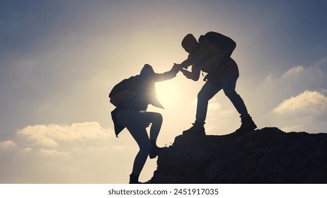 business. teamwork helps hand down business silhouette concept. a group of tourists lend a helping hand, climbing rocks, mountains, lend helping hand. teamwork people climbers climb to top travel - Powered by Shutterstock