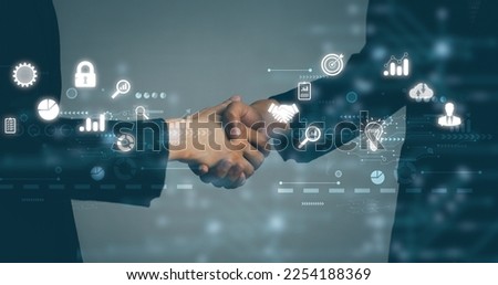 Business and Technology. Businessman and Businesswoman shake hands blurred background, white digital and interface icon. 