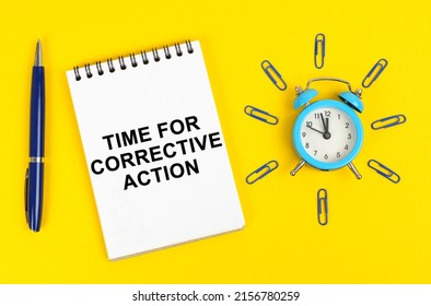 Business and technology concept. On a yellow surface there is an alarm clock, a pen and a notepad with the inscription - Time for Corrective Action