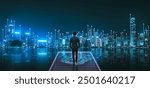 Business technology concept, Professional business man walking on future Hong Kong city background and futuristic interface graphic at night, in Victoria Harbour, Cyberpunk color style