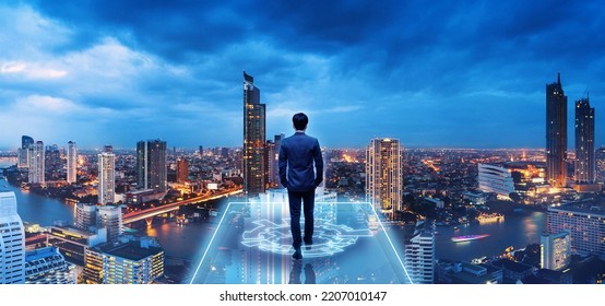 Business technology concept, Professional business man walking on future Bangkok city background and futuristic interface graphic at night, Cyberpunk color style - Shutterstock ID 2207010147