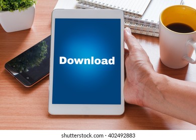 Business and Technology concept.Tablet with text inside DOWNLOAD on the table
