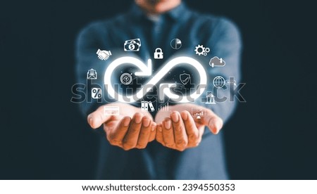 Business technology data link network concept. Businessman Hand show virtual infinity loop technology marketing online icon symbol of endless connection to community metaverse world network system