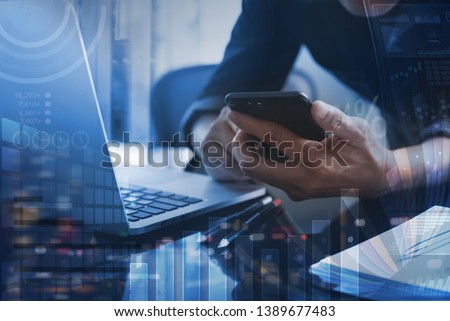 Business technology, business intelligence concept, digital diagram, graph interface. Businessman working at modern office. Man using mobile smart phone, laptop with financial data, dashboard computer
