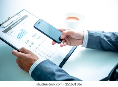 business, technology and internet concept - close up of man hands with coffee and laptop computer - Shutterstock ID 251681386