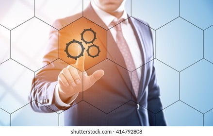 business, technology, internet, engineering and virtual reality concept - businessman pressing mechanism button on virtual screens with hexagons and transparent honeycomb