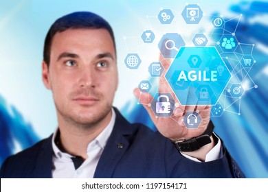 Business, Technology, Internet And Network Concept. Young Businessman Working On A Virtual Screen Of The Future And Sees The Inscription: Agile