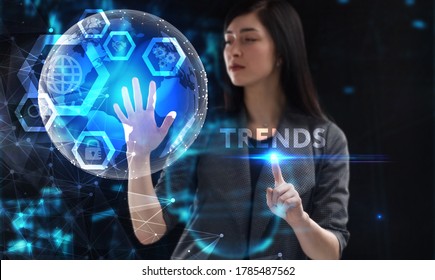 Business, Technology, Internet And Network Concept. Young Businessman Working On A Virtual Screen Of The Future And Sees The Inscription: Trends