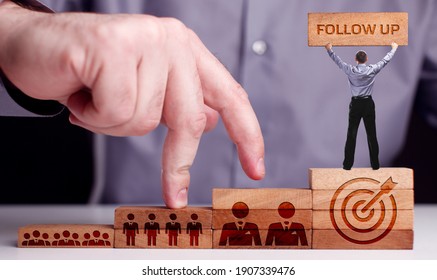 Business, Technology, Internet and network concept. Young businessman shows the word: Follow up - Shutterstock ID 1907339476
