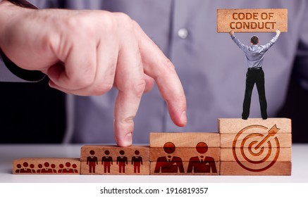Business, Technology, Internet And Network Concept. Young Businessman Shows The Word:Code Of Conduct 
