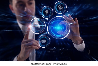 Business, Technology, Internet And Network Concept. Young Businessman Working On A Virtual Screen Of The Future And Sees The Inscription: Trends