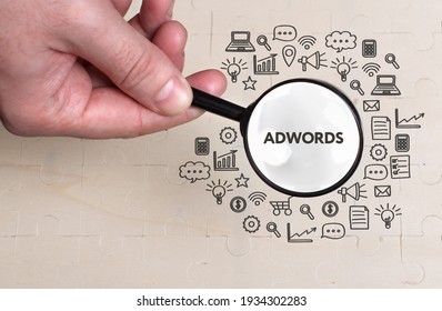 Business, technology, internet and network concept. Young businessman thinks over the steps for successful growth: AdWords