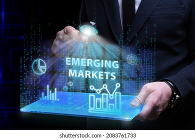 Business, Technology, Internet and network concept. Young businessman working on a virtual screen of the future and sees the inscription: Emerging markets - Shutterstock ID 2083761733