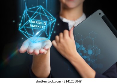 Business, Technology, Internet and network concept. Young businessman working on a virtual screen of the future and sees the inscription: Emerging markets - Shutterstock ID 2141285849
