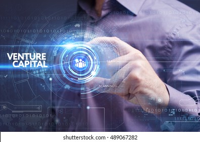 Business, Technology, Internet and network concept. Young businessman working on a virtual screen of the future and sees the inscription: venture capital