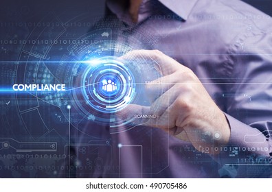 Business, Technology, Internet and network concept. Young businessman working on a virtual screen of the future and sees the inscription: compliance