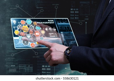 Business, Technology, Internet And Network Concept. Young Businessman Working On A Tablet Of The Future, He Sees The Inscription: Risk Management 