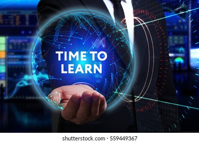 Business, Technology, Internet and network concept. Young businessman working in the field of the future, he sees the inscription: time to learn 