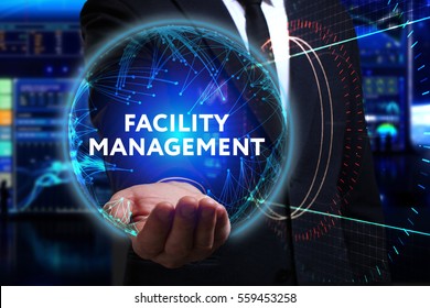 Business, Technology, Internet And Network Concept. Young Businessman Working In The Field Of The Future, He Sees The Inscription: Facility Management 