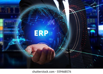 Business, Technology, Internet and network concept. Young businessman working in the field of the future, he sees the inscription: ERP  - Shutterstock ID 559468576