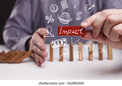 Business, Technology, Internet And Network Concept. Young Businessman Shows The Word: Impact 