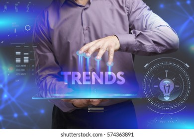 Business, Technology, Internet And Network Concept. Young Businessman Shows The Word On The Virtual Display Of The Future: Trends