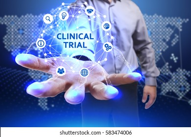 Business, Technology, Internet And Network Concept. Young Businessman Shows The Word On The Virtual Display Of The Future: Clinical Trial