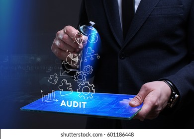 Business, Technology, Internet and network concept. Young businessman working on a virtual screen of the future and sees the inscription: Audit