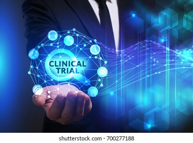 Business, Technology, Internet and network concept. Young businessman working on a virtual screen of the future and sees the inscription: Clinical trial - Shutterstock ID 700277188
