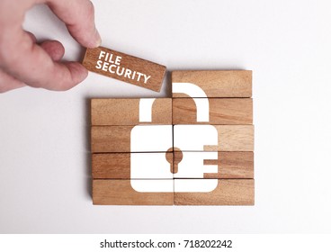Business, Technology, Internet and network concept. Young businessman shows the word: File security - Shutterstock ID 718202242