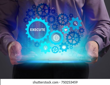 Business, Technology, Internet and network concept. Young businessman working on a virtual screen of the future and sees the inscription: Execute