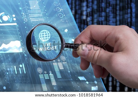 Business, Technology, Internet and network concept. Young businessman working on a virtual screen of the future and sees the inscription: Live webcast