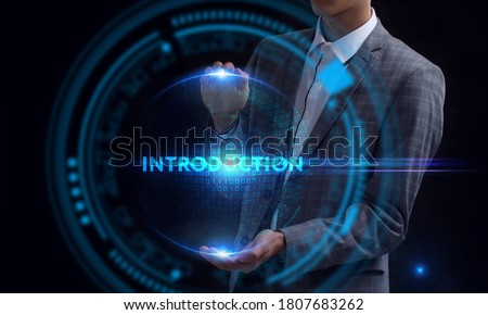 Business, Technology, Internet and network concept. Young businessman working on a virtual screen of the future and sees the inscription: Introduction
