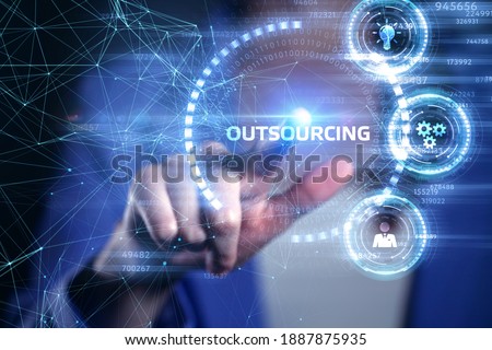 Business, Technology, Internet and network concept. Young business man writing word: Outsourcing