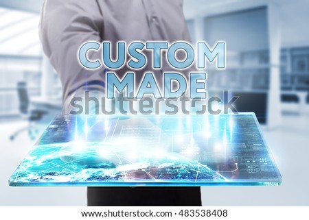 Business, Technology, Internet and network concept. Young businessman working on a tablet of the future, he sees the inscription: custom made