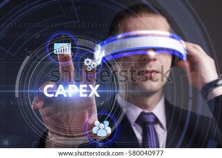 Business, Technology, Internet and network concept. Young businessman working in virtual reality glasses sees the inscription: Capex