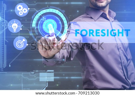 Business, Technology, Internet and network concept. Young businessman working on a virtual screen of the future and sees the inscription: Foresight