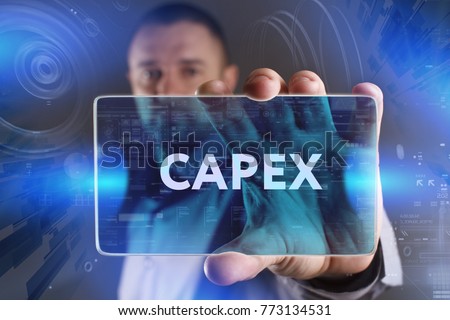 Business, Technology, Internet and network concept. Young businessman working on a virtual screen of the future and sees the inscription: Capex