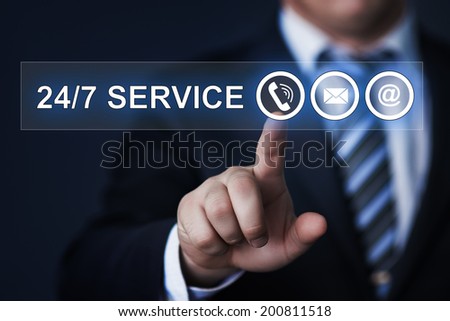 business, technology, internet and networking concept - businessman pressing 24/7 service button on virtual screens