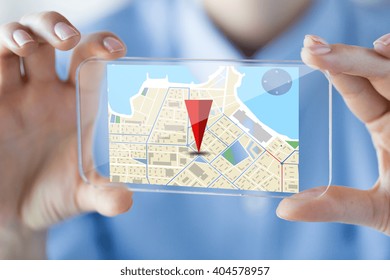 Business, Technology, Navigation, Location And People Concept - Close Up Of Woman Hand Holding And Showing Transparent Smartphone With Gps Navigator Map On Screen At Office