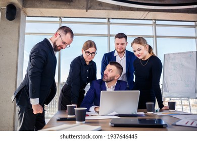 Business, Technology And Office Concept - Happy Business Team With Laptop Computers, Documents And Coffee. Meeting Before The Start Of The Working Day To Discuss A Business Plan