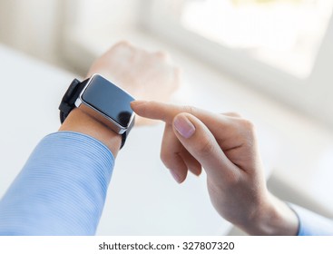 Business, Technology And People Concept - Close Up Of Woman Hands Setting Smart Watch At Office