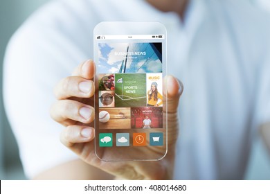 business, technology and people concept - close up of male hand holding and showing transparent smartphone news web page on screen - Powered by Shutterstock