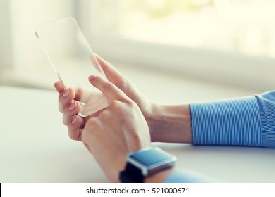 Business, Technology And People Concept - Close Up Of Woman Hand Holding And Showing Transparent Smart Phone And Watch At Office