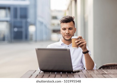 business, technology and people concept - young man with laptop computer and coffee cup at city street cafe - Shutterstock ID 531995548